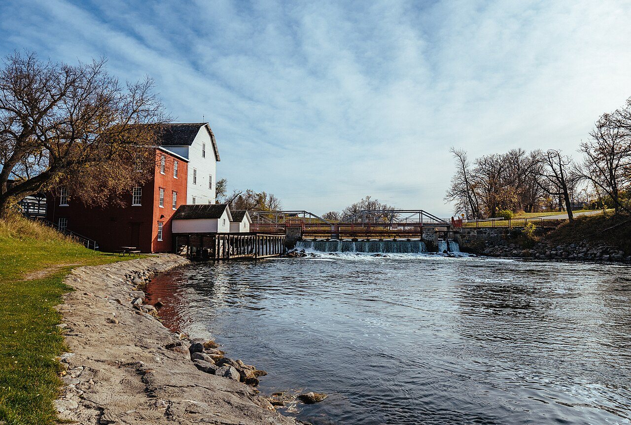 The red and white Phelps Mill beside the dam on the Otter Tail River